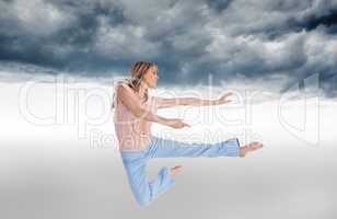 Composite image of woman doing dance pose