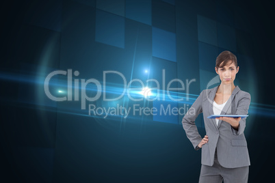 Composite image of attractive businesswoman holding tablet pc