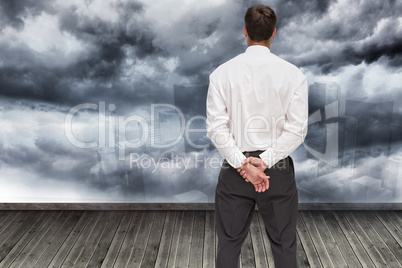 Composite image of businessman turning his back to camera