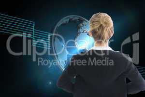 Composite image of businesswoman standing with hands on hips