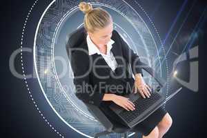 Composite image of businesswoman sitting on swivel chair with la