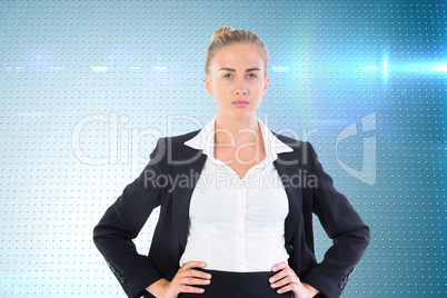 Composite image of businesswoman standing with hands on hips