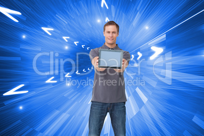 Composite image of young man showing screen of his tablet comput