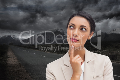 Composite image of smiling businesswoman thinking