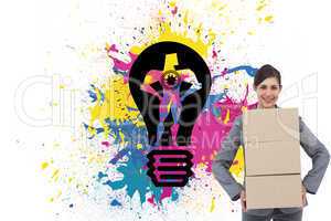 Composite image of smiling businesswoman carrying cardboard boxe