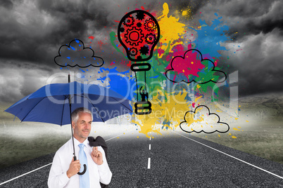 Composite image of happy businessman holding umbrella