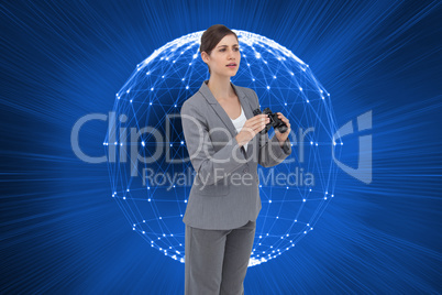 Composite image of curious young businesswoman with binoculars