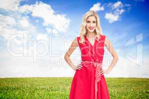 Composite image of smiling blonde standing hands on hips