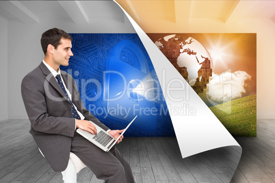 Composite image of businessman using laptop