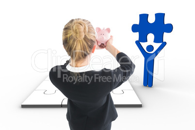 Composite image of businesswoman holding pink piggy bank