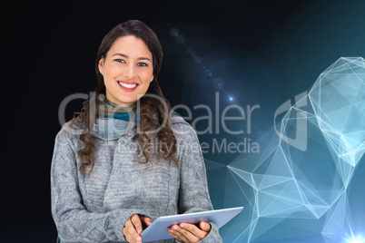 Composite image of smiling model wearing winter clothes holding