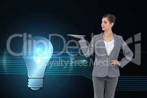 Composite image of businesswoman holding tablet computer