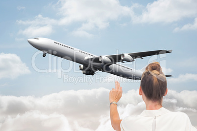 Composite image of businesswoman touching something