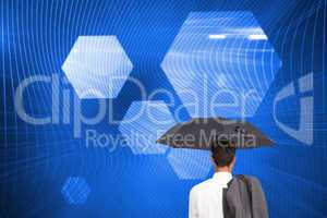 Composite image of businessman standing back to camera holding u