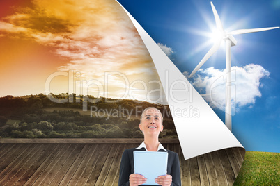 Composite image of businesswoman holding new tablet