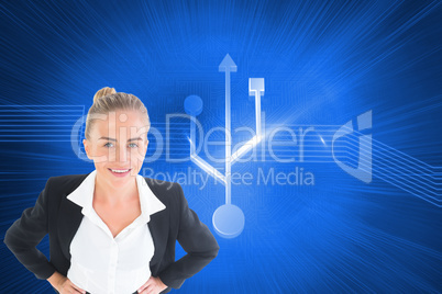 Composite image of businesswoman standing with hands on hips