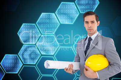 Composite image of serious architect holding plans and hard hat