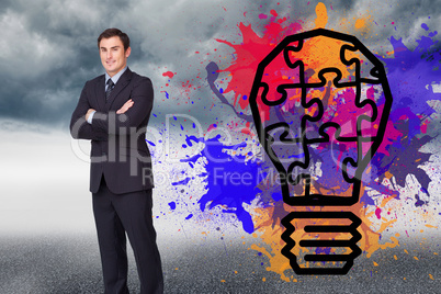 Composite image of young businessman standing cross-armed