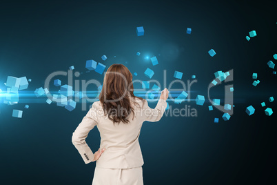 Composite image of businesswoman standing back to camera writing