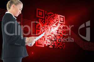 Composite image of businesswoman holding tablet