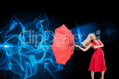 Composite image of elegant blonde holding umbrella