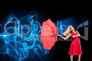 Composite image of elegant blonde holding umbrella