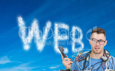 Composite image of confused it professional with cables and phon