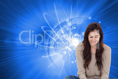 Composite image of brunette sitting on floor using laptop