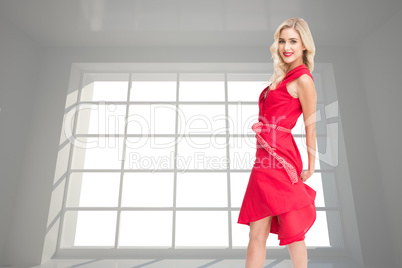 Composite image of smiling blonde turning