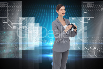 Composite image of curious young businesswoman with binoculars