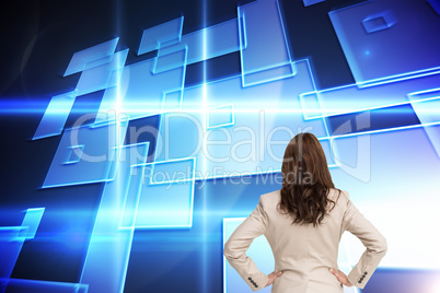 Composite image of businesswoman standing back to camera