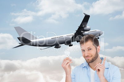 Composite image of charming model holding a bulb in right hand