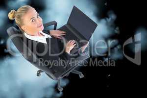 Composite image of businesswoman sitting on swivel chair with la