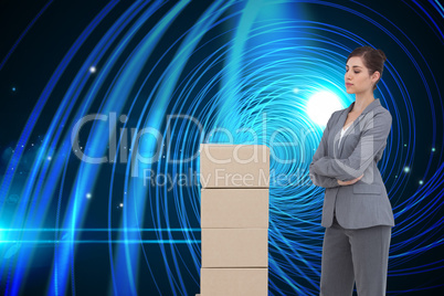 Composite image of thoughtful woman with cardboard boxes