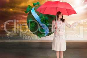 Composite image of attractive businesswoman holding red umbrella