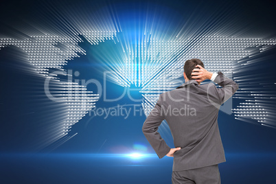 Composite image of young businessman standing back to camera scr