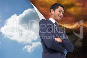 Composite image of smiling asian businessman with arms crossed