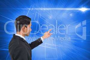 Composite image of stern asian businessman pointing