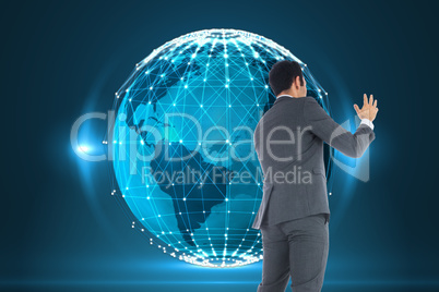 Composite image of businessman with arms raised