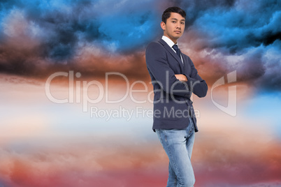 Composite image of unsmiling casual businessman with arms crosse