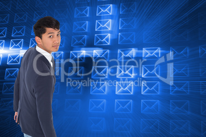 Composite image of unsmiling casual businessman walking