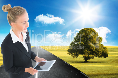 Composite image of businesswoman holding new tablet