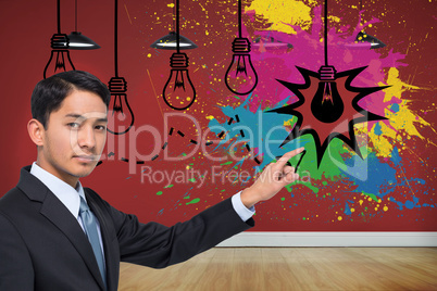 Composite image of stern asian businessman pointing