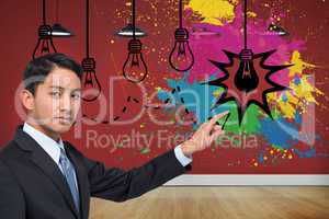 Composite image of stern asian businessman pointing