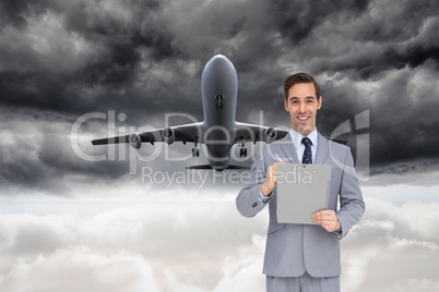 Composite image of happy businessman holding a clipboard