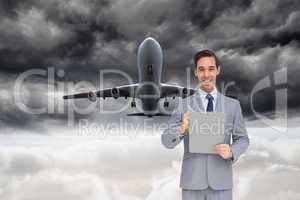 Composite image of happy businessman holding a clipboard