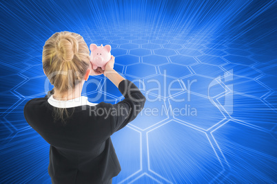 Composite image of businesswoman holding pink piggy bank Composite image of businesswoman holding pink piggy bank
