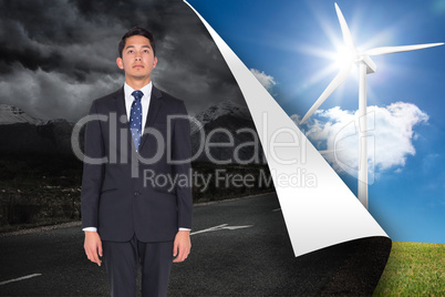 Composite image of serious businessman looking up
