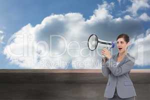 Composite image of businesswoman with loudspeaker