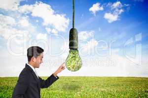 Composite image of smiling asian businessman pointing